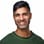 Khurram Naik smiling in a green sweater